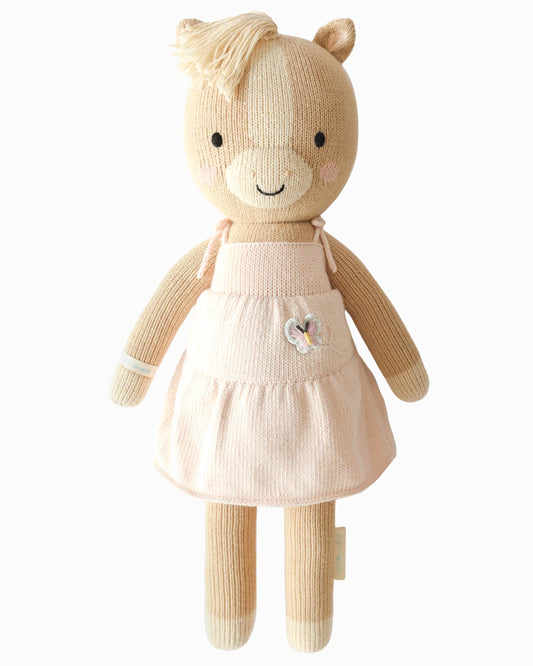 Knitted toy pony in a pink dress with a butterfly embellishment