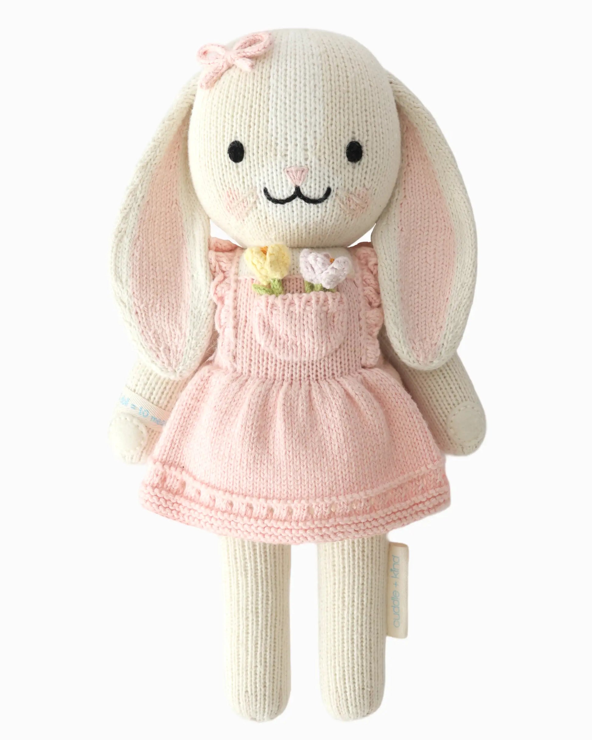 Knitted bunny toy in a pink dress with a front pocket with flowers