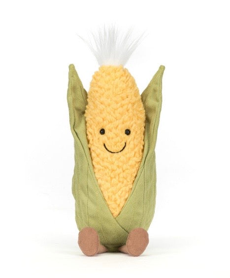 Corn-shaped plush toy with a smiling face on a white background
