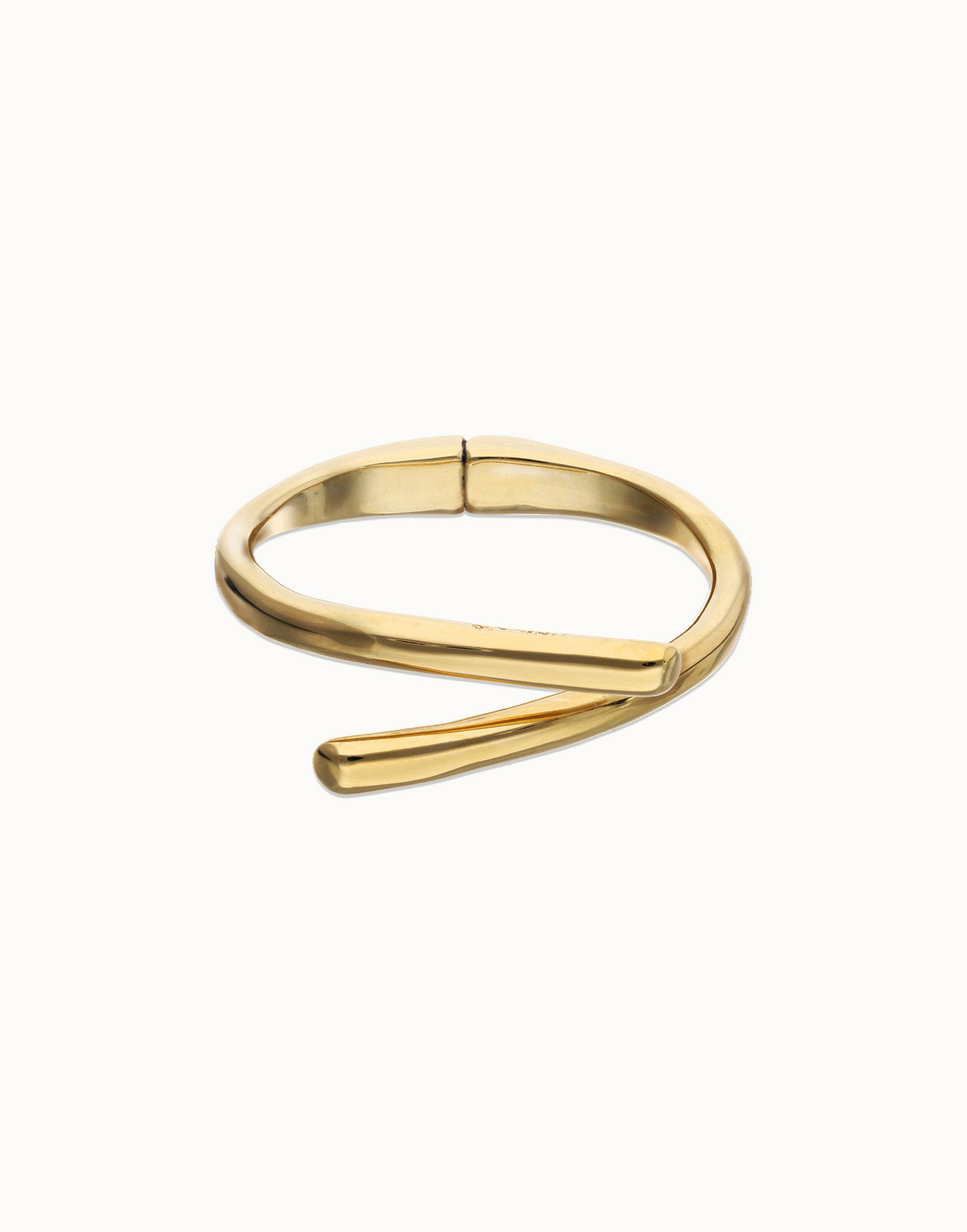 UNO de 50 Gold bangle bracelet that resembles twisted metal on a white background 