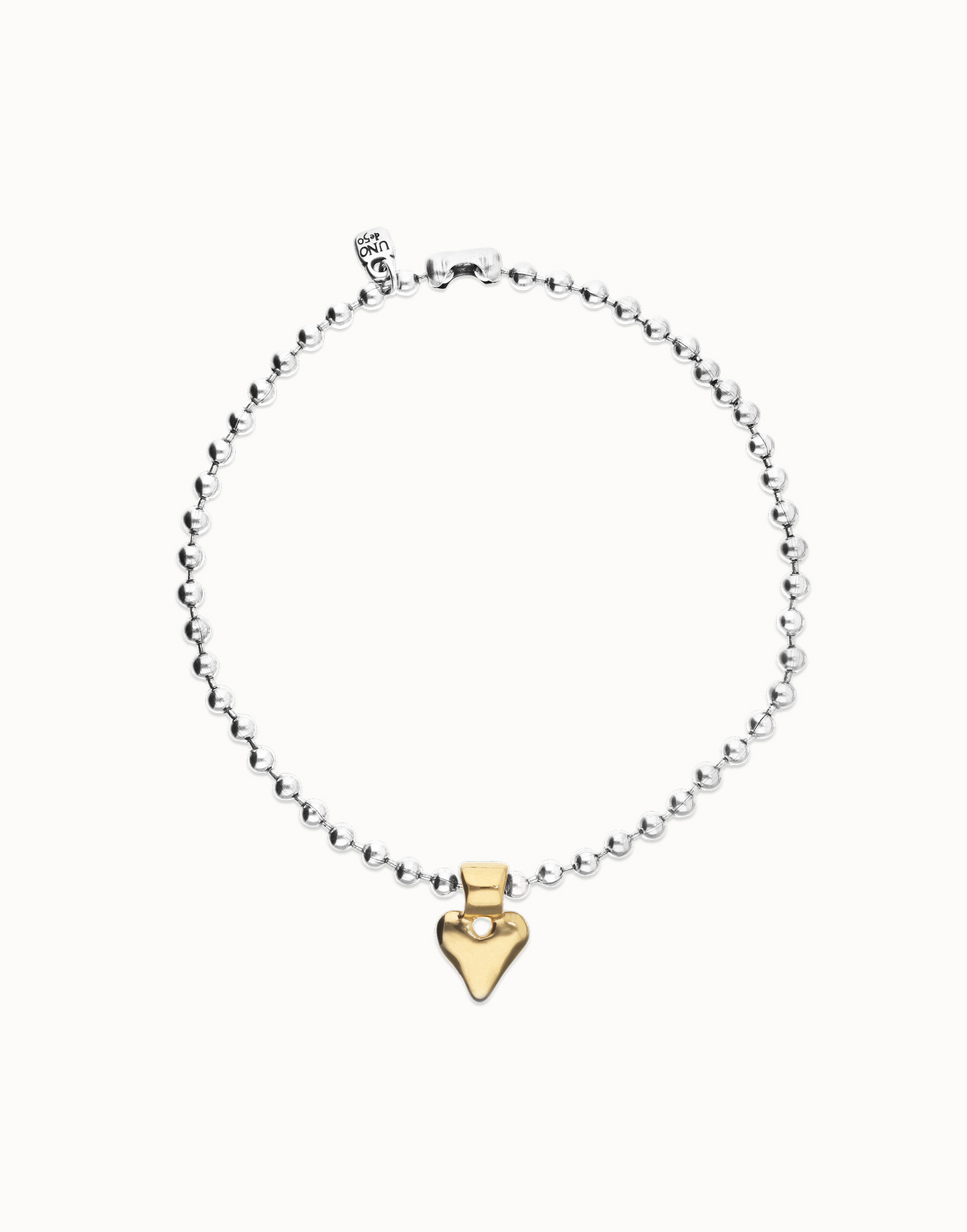 Gold heart-shaped pendant on a silver chain against a white background