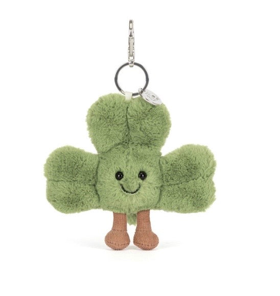 Green plush keychain with a smiling face on a white background