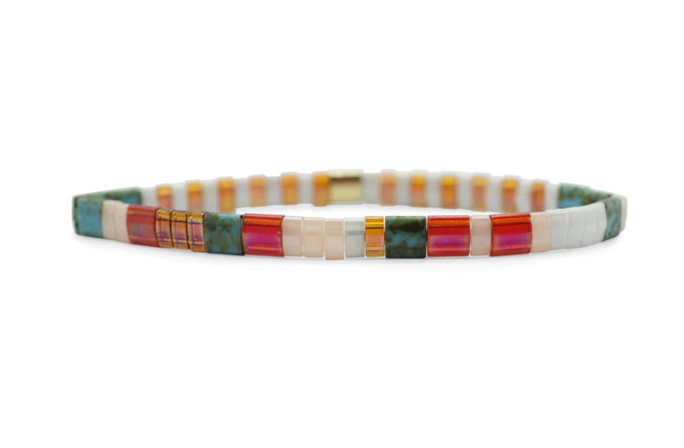 A Morse code bead pattern bracelet with a multicolored design, featuring the text 'JUST BEACHY' and assembled with Japanese glass MiyukI beads.
