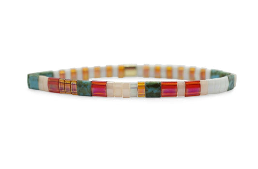 A Morse code bead pattern bracelet with a multicolored design, featuring the text 'JUST BEACHY' and assembled with Japanese glass MiyukI beads.