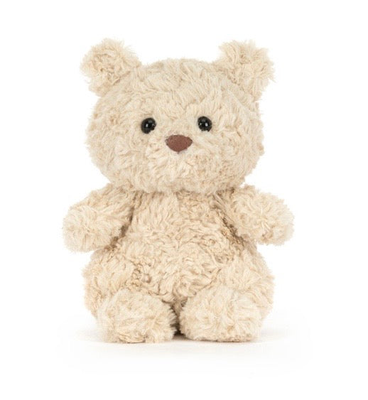 Cuddly beige teddy bear on a white background