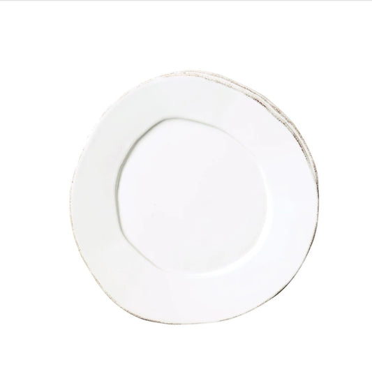 A white salad plate with rustic brown highlights.