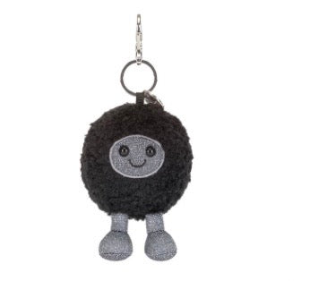 Black pom-pom keychain with a smiling face on a white background