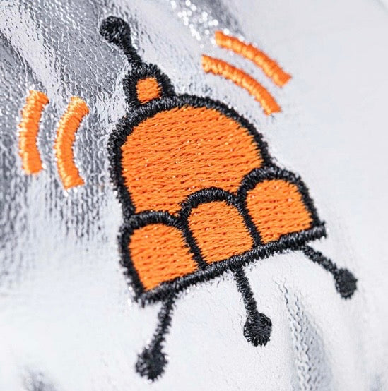 Embroidered cartoon bee design on a white fabric background
