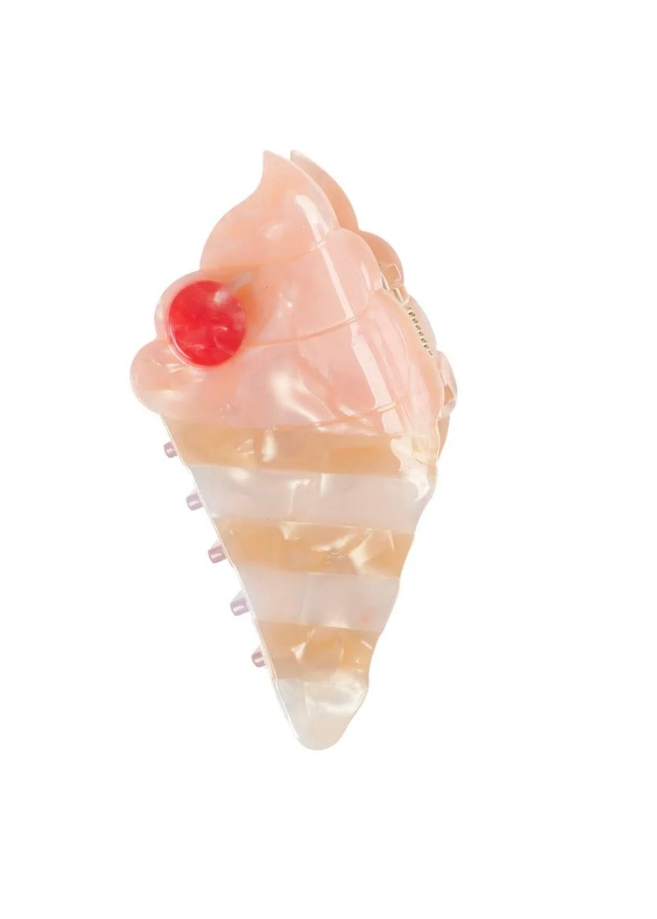 Ice cream cone-shaped hair clip with pink and white swirls and a red cherry on top 