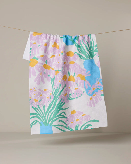 Geometry Floral-patterned towel hanging on a line against a beige background