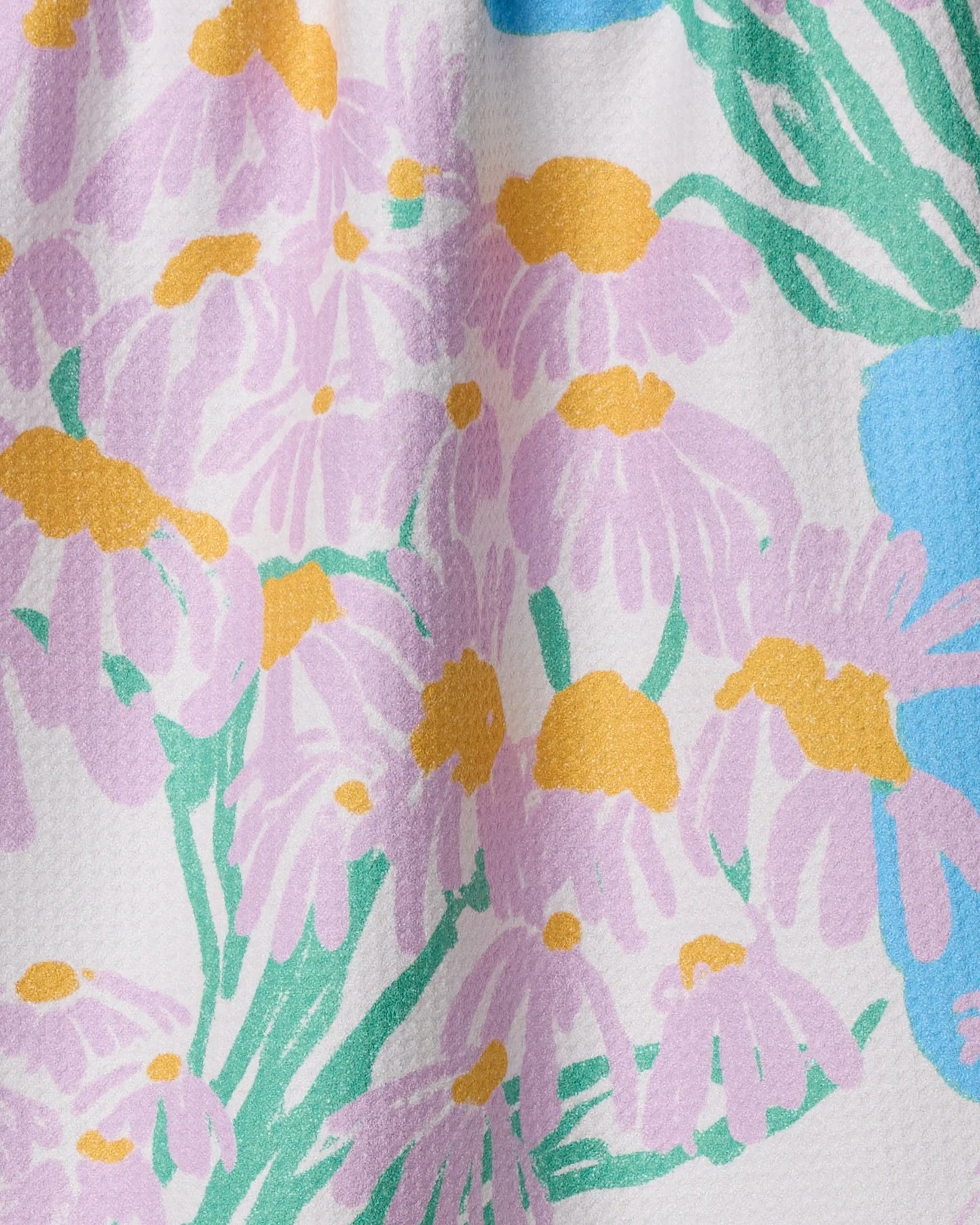 Geometry Close-up of a fabric with a colorful floral pattern featuring purple flowers with yellow centers.