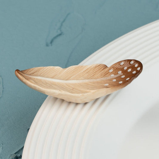 nora fleming mini of a quill designed to be a feather with shades of brown