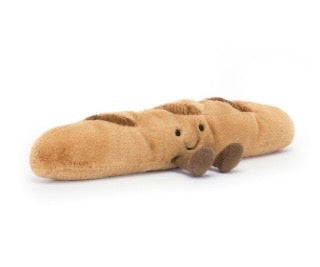 Plush baguette toy with a face on a white background