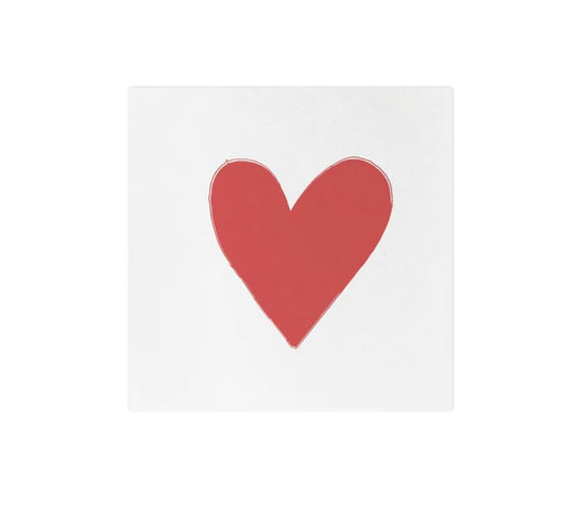 A white cocktail napkin with a red heart design in the center.