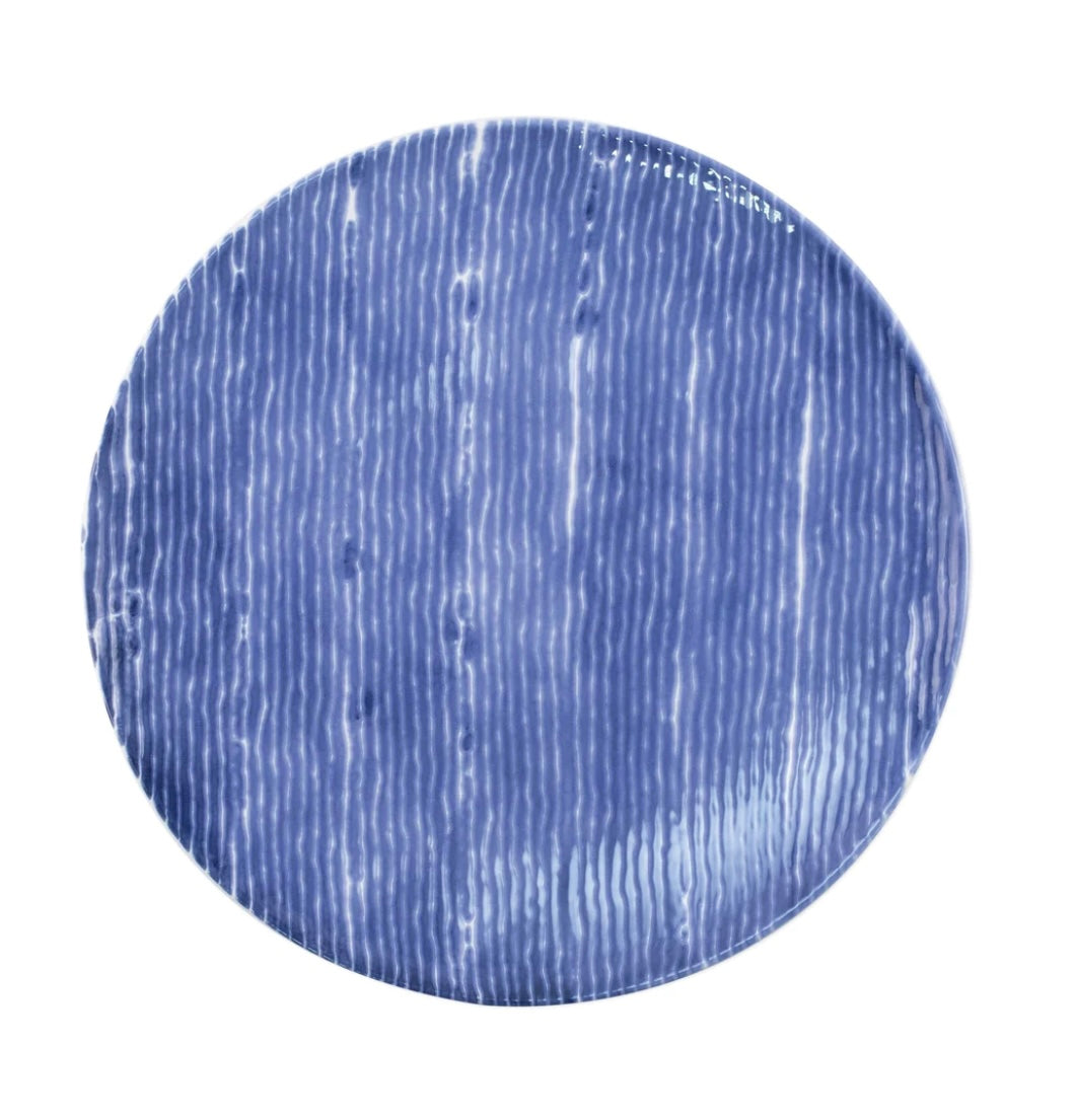 A round ceramic dinner plate with a blue and white striped pattern.
