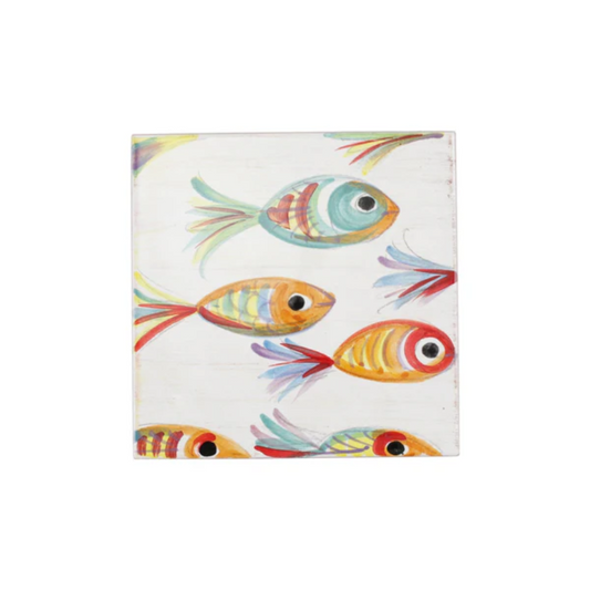 Colorful fish design on a white trivet