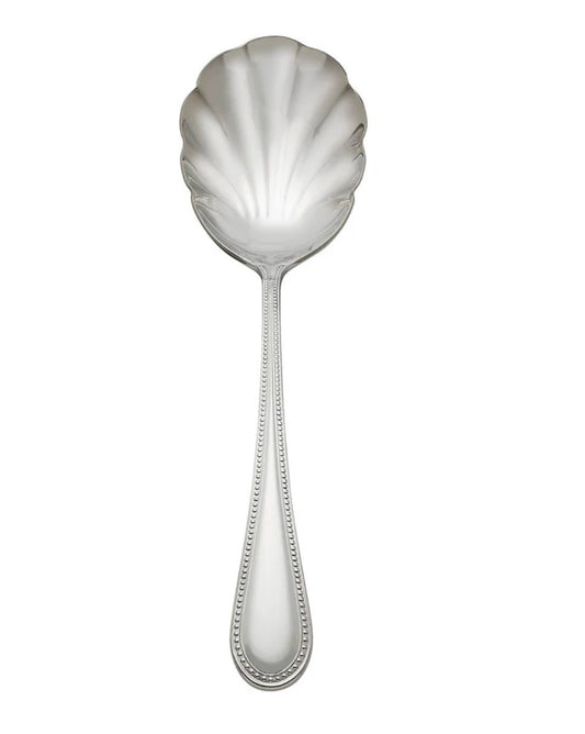 Silver shell-shaped spoon on a white background
