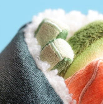 Close-up of fabric with green and orange patterns of sushi