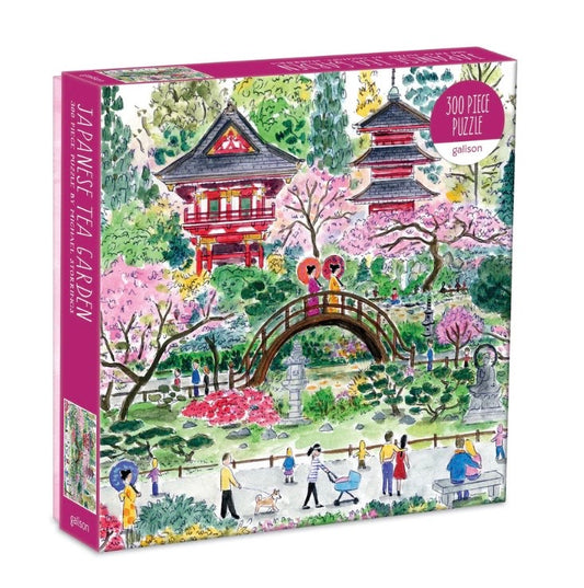 Jigsaw puzzle box featuring a Japanese tea garden scene with cherry blossoms and traditional architecture.