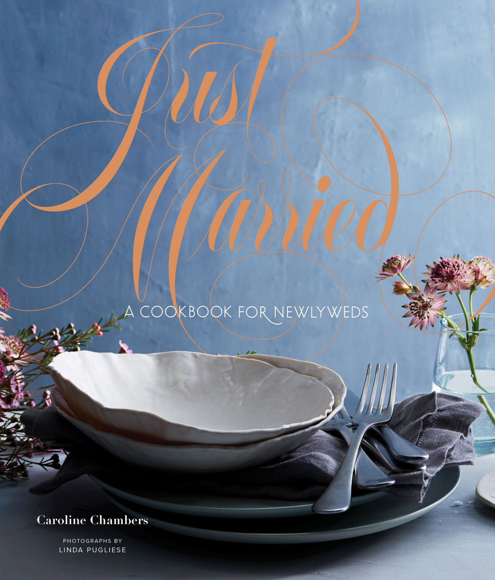 Cookbook cover titled 'Just Married' with a table setting and flowers on a blue background