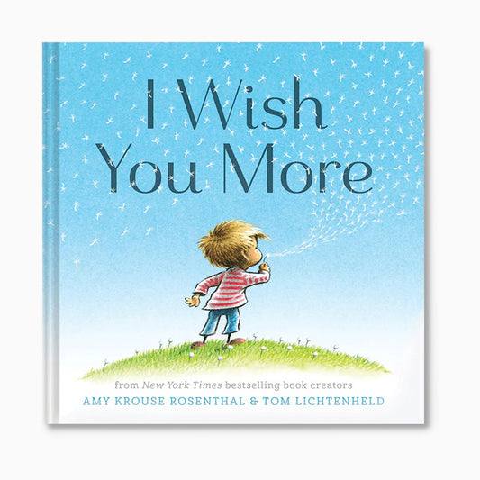 Book cover of 'I Wish You More' with a child blowing bubbles against a blue sky.