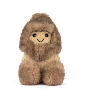 Stuffed animal toy resembling a character in a fur outfit on a white background