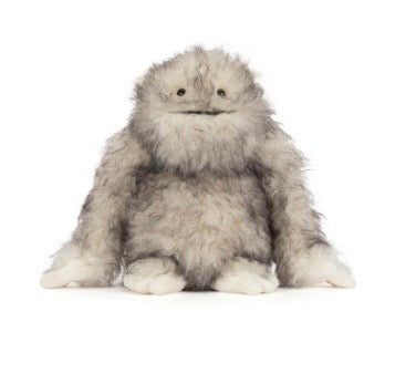 Plush toy resembling a fluffy creature on a white background