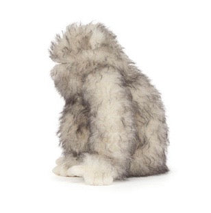 Plush toy resembling a fluffy creature on a white background