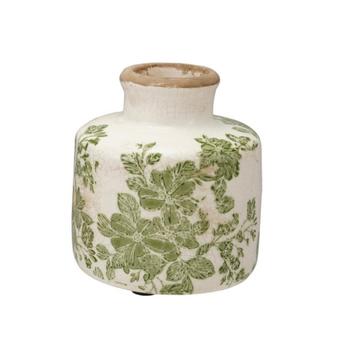 white ceramic vase with a green botanical design