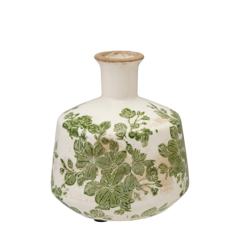 white ceramic vase with a green botanical design