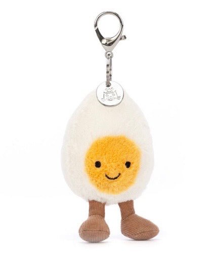 Plush keychain shaped like a boiled egg with a smiling face 