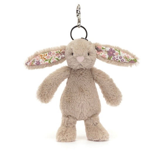 Fluffy beige bunny keychain with floral ears on a white background