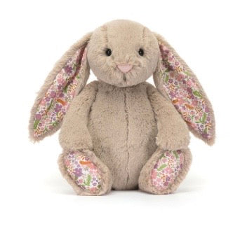 Floral-patterned plush bunny toy on a white background