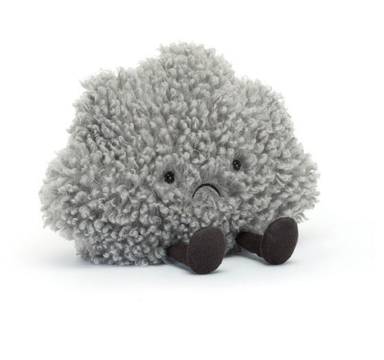Plush toy hedgehog with a sad expression on a white background