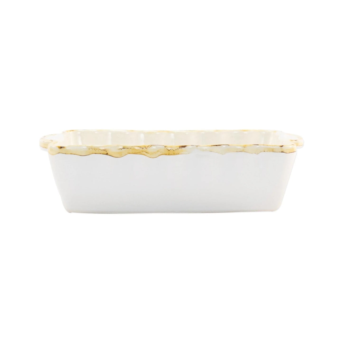 A small rectangular white stoneware baker with scalloped edges and a rustic rim.