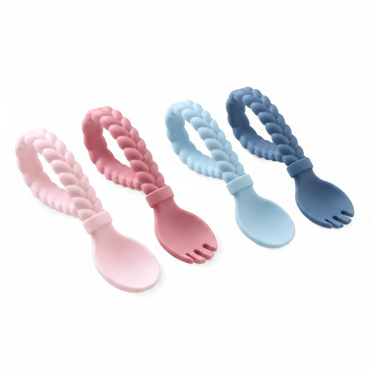 Pink and blue itzy ritzy sweetie silicone spoon and fork set with braided handles on a white background