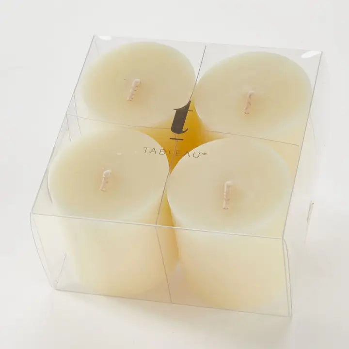 Set of four white candles in a clear plastic packaging with 'Tableau' branding.