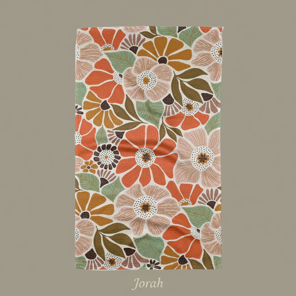 Floral patterned Geometry Jorah tea towel with orange, green, and brown colors on a white background