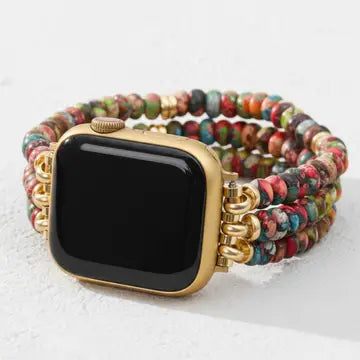 Multicolored beaded kaleidoscope boho stretch apple watch band with gold accents on a white surface by cape diablo