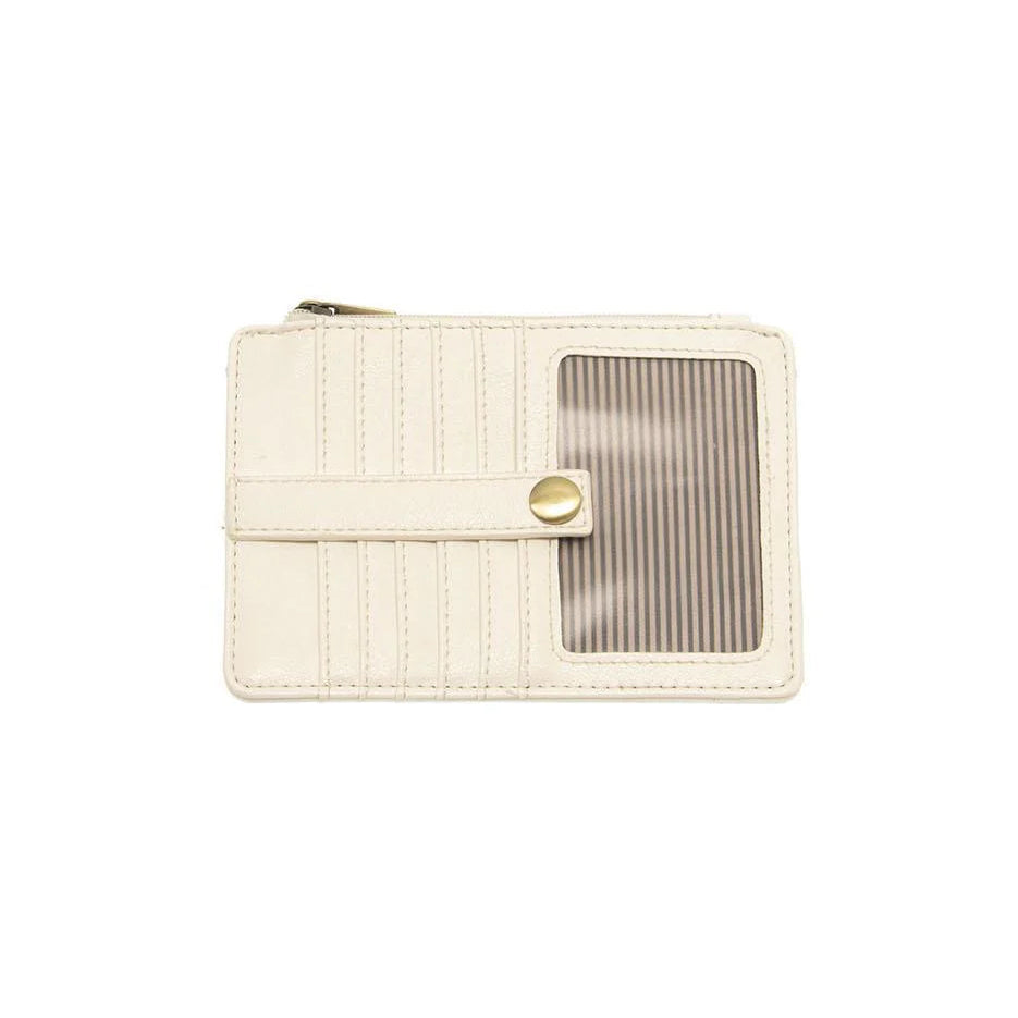 A white vegan leather mini travel wallet with a top zip closure, multiple card pockets, an ID window pocket, and an exterior passport pocket. It has brass plated hardware and is slim enough for travel use.