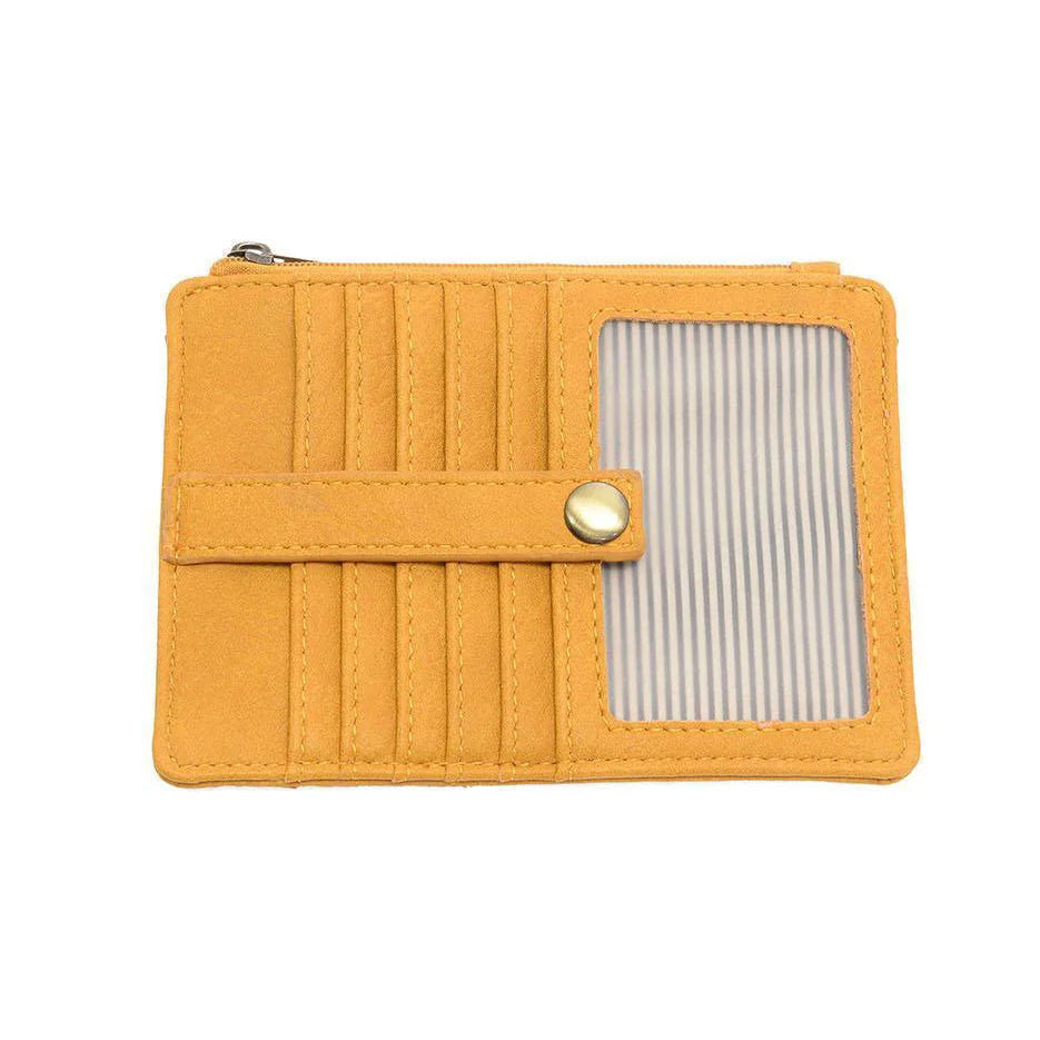 A honey yellow vegan leather mini travel wallet with a top zip closure, multiple card pockets, an ID window pocket, and an exterior passport pocket. It has brass plated hardware and is slim enough for travel use.