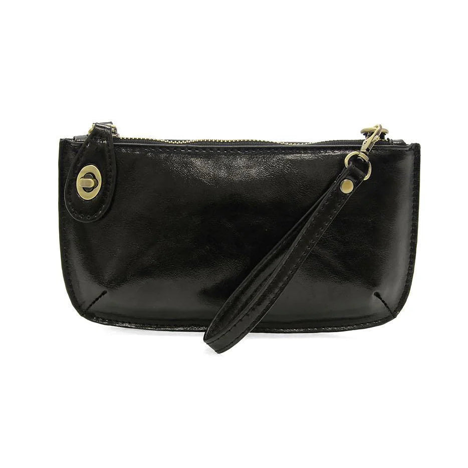 A metallic black mini crossbody wristlet clutch with brass plated hardware and a removable wrist strap.