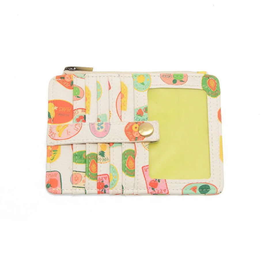 A multi-colored vegan leather mini travel wallet with a top zip closure, multiple card pockets, an ID window pocket, and an exterior passport pocket. It has brass plated hardware and is slim enough for travel use.