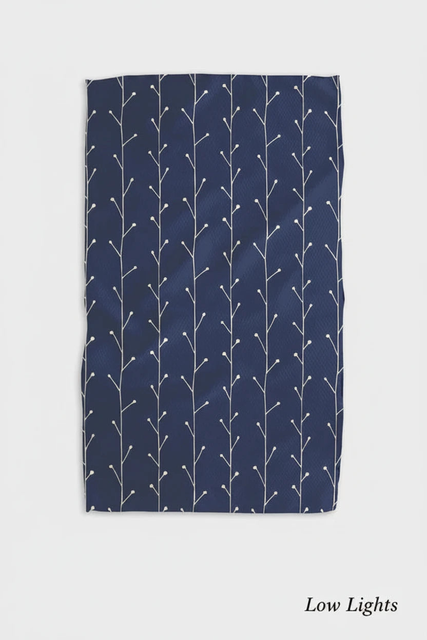 A blue kitchen Geometry low lights tea towel with a white geometric pattern displayed flat.