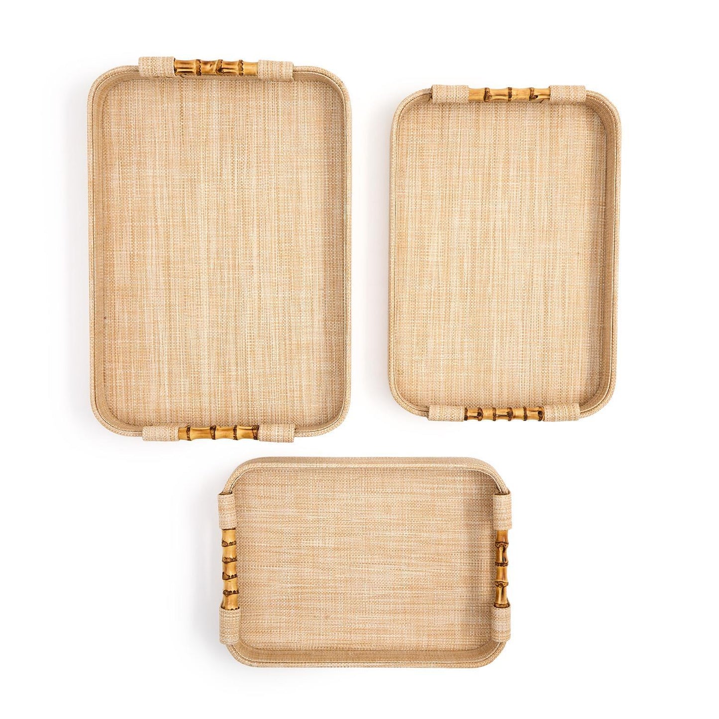 Three rectangular rattan trays with bamboo handles on a white background