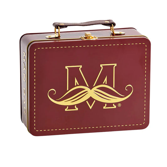 Maroon box with gold logo of a moustache and letter M