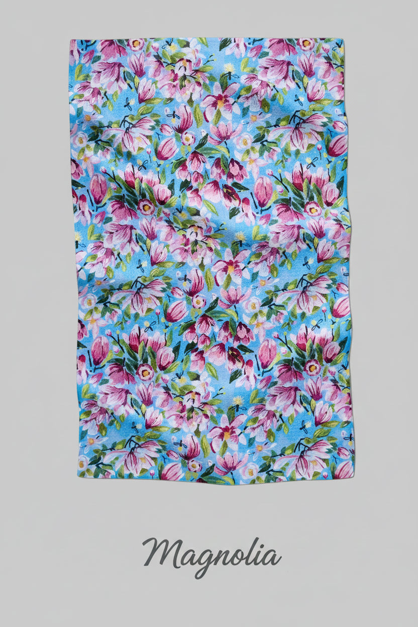 Floral Geometry Magnolia tea towel with pink and purple flowers on a blue background
