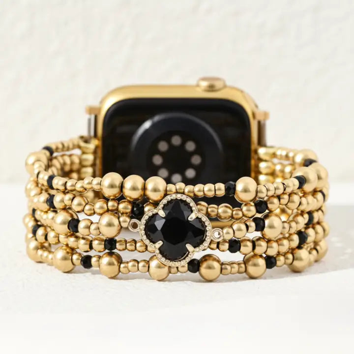 Gold beaded Majestic Midnight stretch apple watch strap by cape diablo with a black stone on a white background