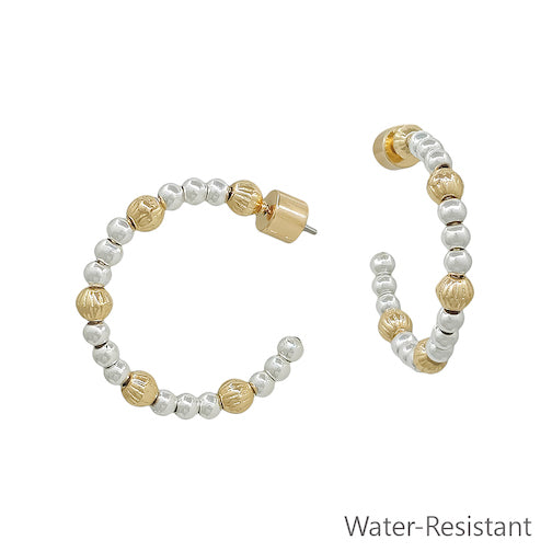 Meghan Browne NULA-GS hoop earrings with a gold stud and alternating one stamped gold bead then three slightly smaller silver bead pattern mixed metal 