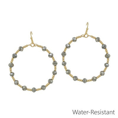 Meghan Brown QUIN-HE gold dangle hoop earrings with black hemotite stones on the hoop